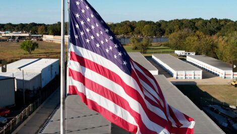 U.S. flag flying over a storage facility.
