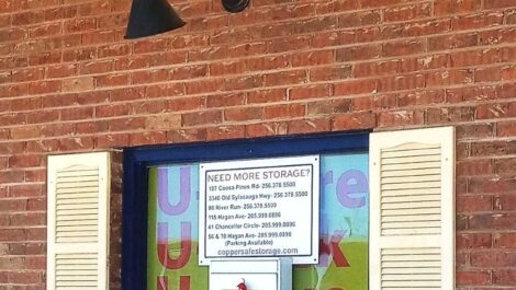 A window with a storage advertisement sign in it.