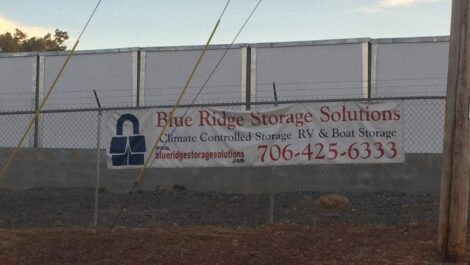 Blue Ridge Storage Solutions flyer hanging on a fence.