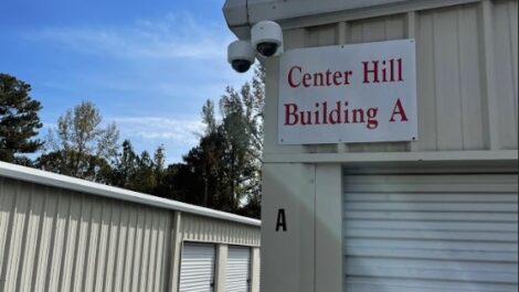 Exterior of storage facility with security cameras and 'Center Hill Building A' sign in in Sylacauga, AL.