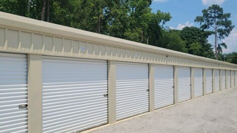 Outdoor storage units with white doors.