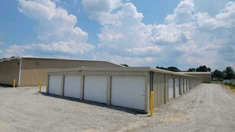 Outdoor view of storage unit section with white doors.