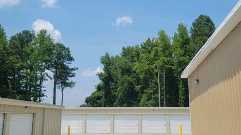 View of storage units on a gravel road.