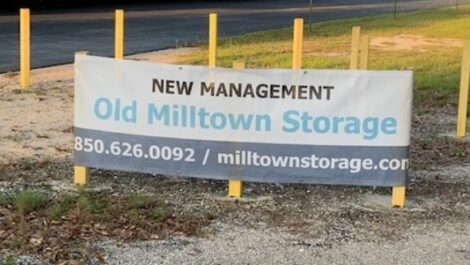 Sign that reads "new management, old milltown storage, 850-626-0092, milltownstorage.com".