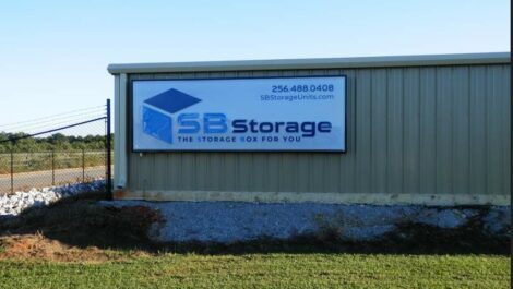 Sign on the outside of a building SB Storage the storage box for you 256-488-0408 sbstorageunits.com outside of the Tuscumbia location.