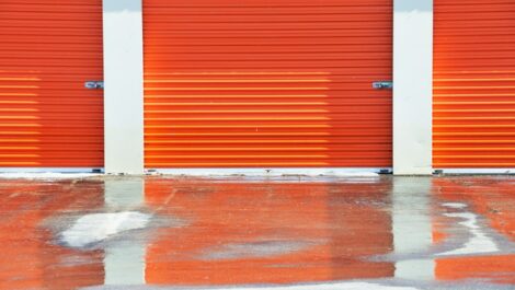 Orange drive up storage unit doors.