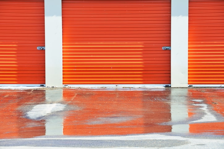 Orange drive up storage unit doors.