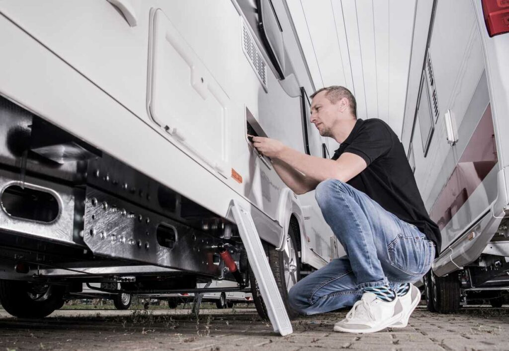 A person doing repair work on the wiring of their RV. 