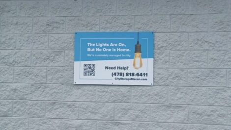 Signage stating the lights are on but no one is home at City Storage in Macon, GA.