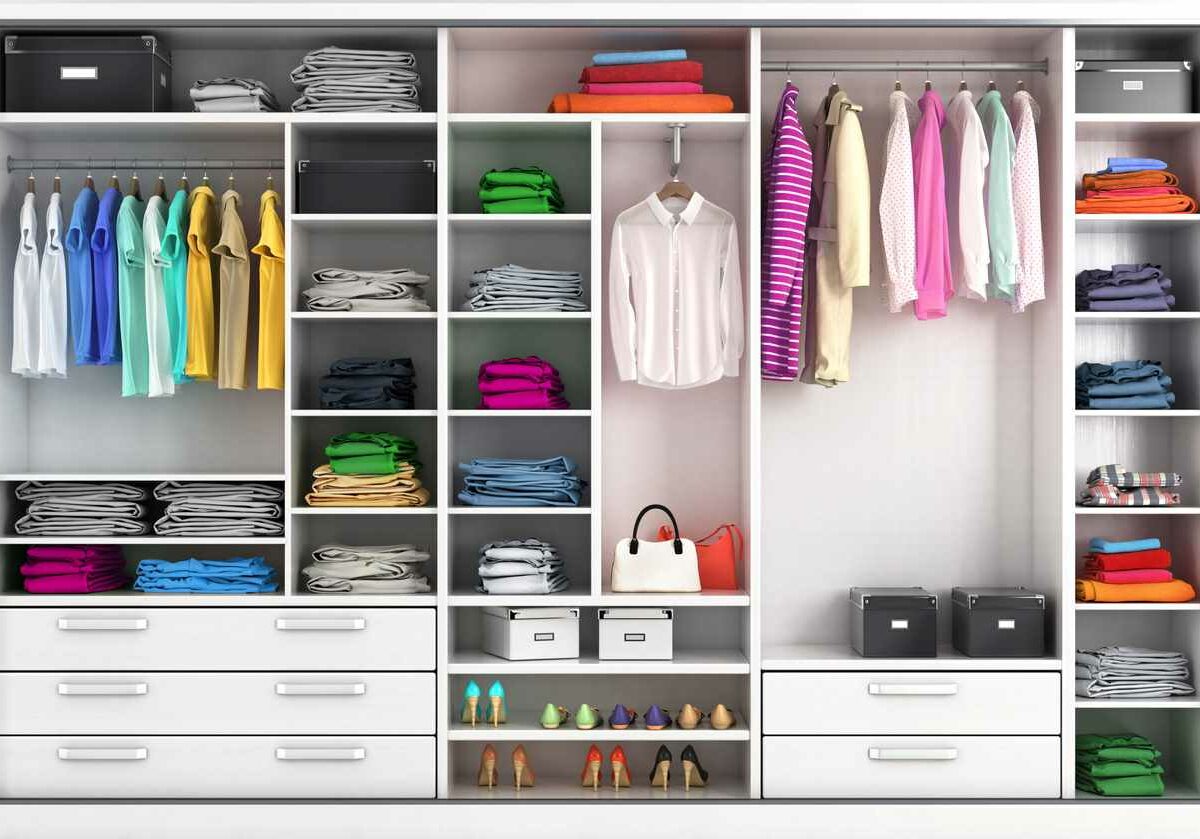 An organized closet with shelves, and a collection of clothes