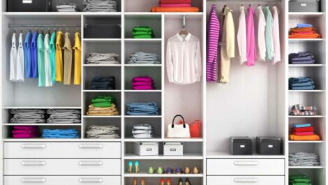 An organized closet with shelves, and a collection of clothes