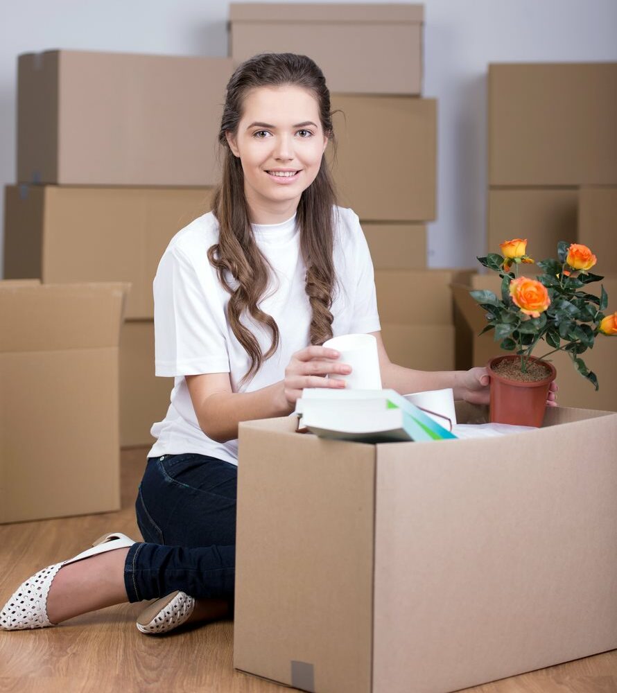 A student packing flowers and books for self storage