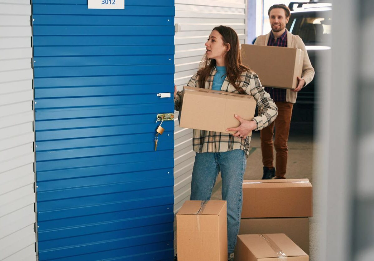 A couple moving their boxes into a storage unit