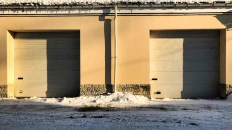 Two storage units side by side in the winter, with snow on the ground out front.