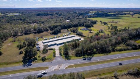 Aerial view of storage facility next to a highway.