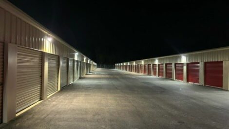 Exterior view at night of outdoor storage units at Safe and Easy Self Storage facility.