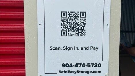 Close of view of pay sign at Safe and Easy Self Storage facility.