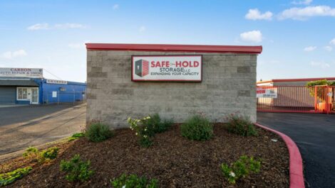 Safe-Hold Storage sign on rock wall.