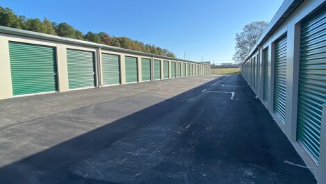 Outdoor storage units with green doors.