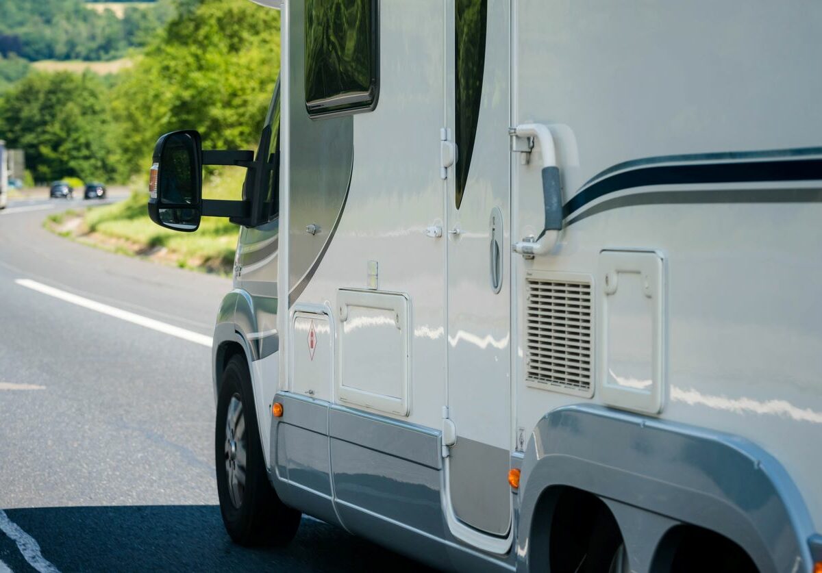 A motorhome driving down the road during the day