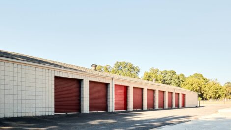 Nine storage units with red doors.