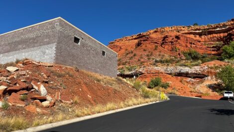 Exterior view of storage facility surrounded by red rocks.