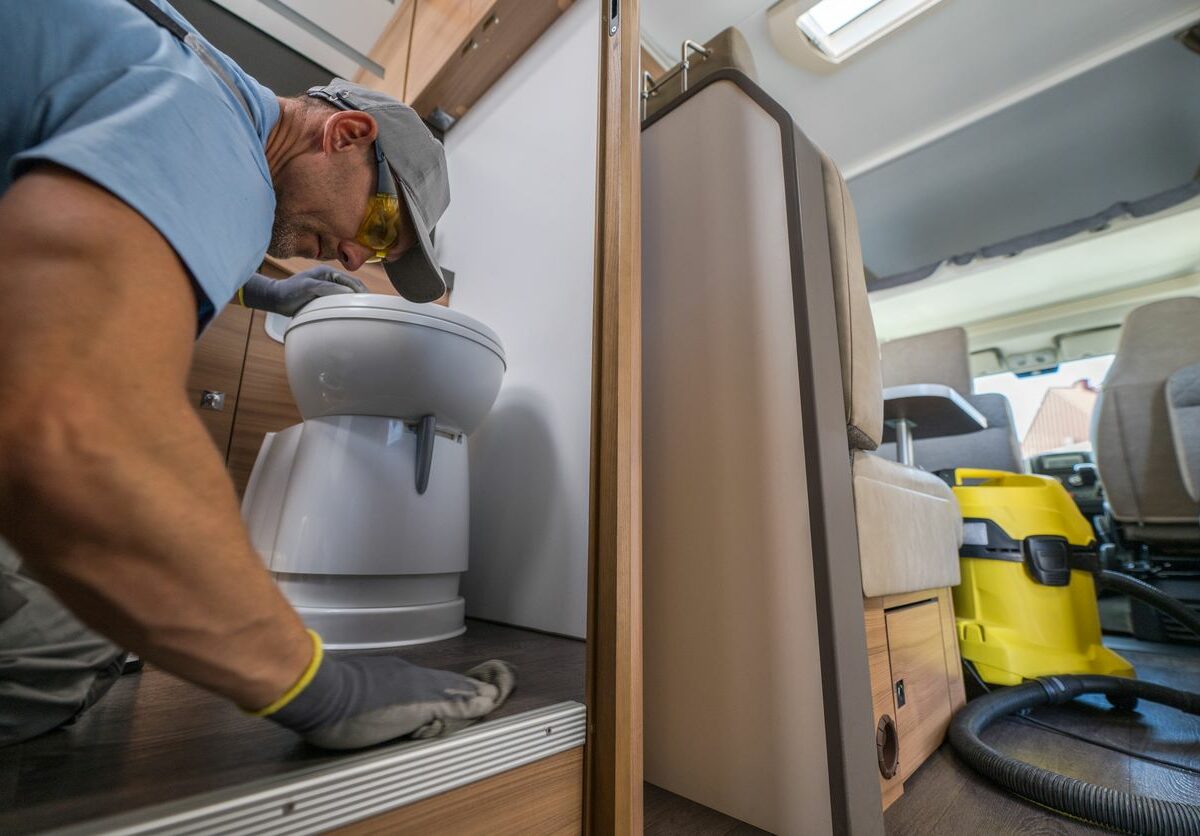 A man cleaning the interior of his RV before storage.