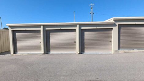 Four tan outdoor storage units.