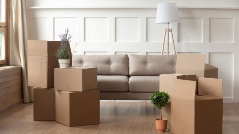 Cardboard moving boxes in a modern living room during a home move.