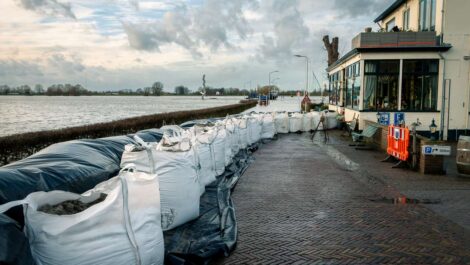 Sandbags protecting homes from floodwaters during heavy rain.